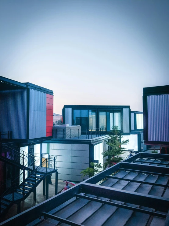 a couple of buildings that are next to each other, a digital rendering, unsplash, modernism, shipping containers, hangzhou, short dof, cinematic full shot