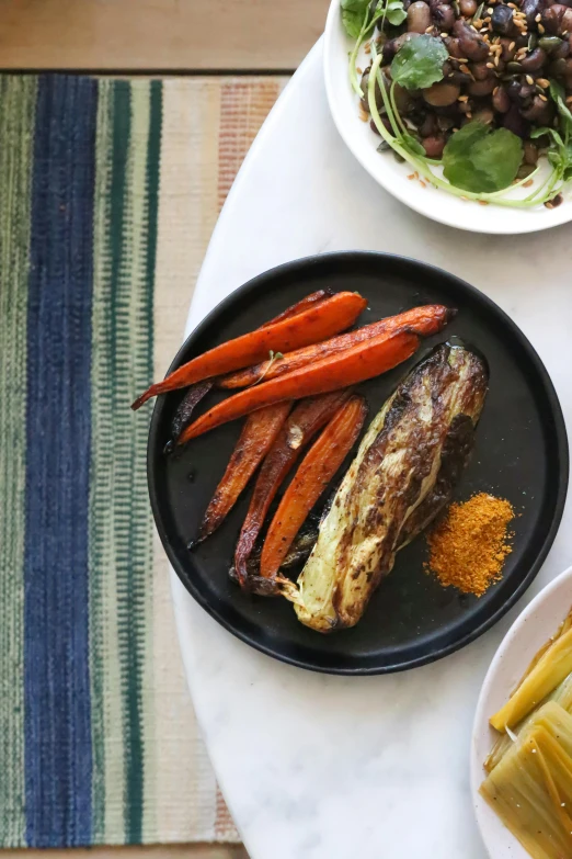 a table topped with plates of food on top of a table, carrots, burnt, indigo, けもの