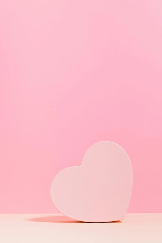 a white heart shaped object on a pink background, by Gavin Hamilton, trending on unsplash, gradient background, 2 d image, woman love woman, chocolate