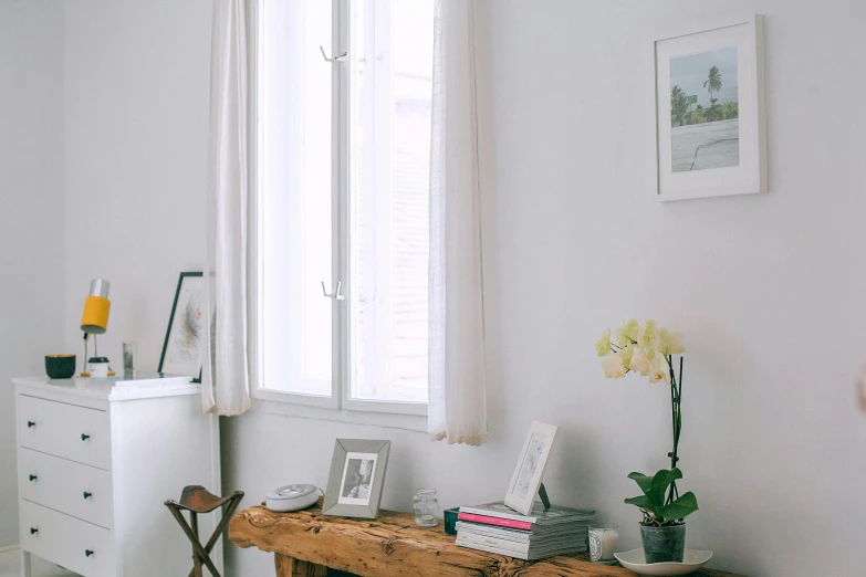 a bed room with a bed a dresser and a window, unsplash, light and space, white sketchbook style, wood table, sitting in french apartment, gallery display photograph