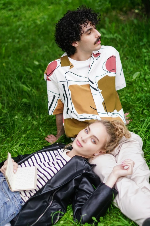 a man and a woman laying in the grass, by Julia Pishtar, visual art, graphic tees, julia garner, modern casual clothing, splash image