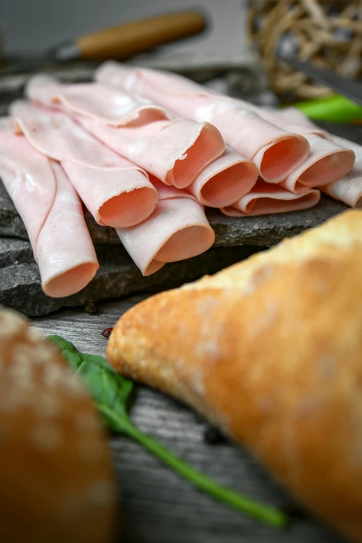 a bunch of meat sitting on top of a cutting board, brown bread with sliced salo, paul barson, longque chen, ham