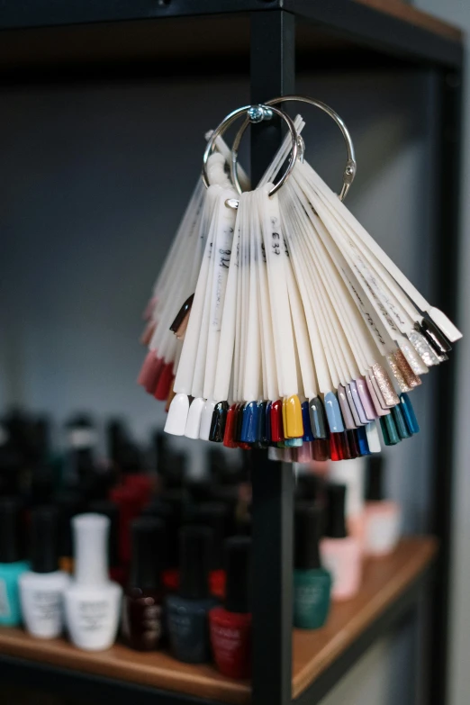 a bunch of hair brushes hanging from a rack, a cartoon, unsplash, painted nails, tubes, dezeen showroom, matte