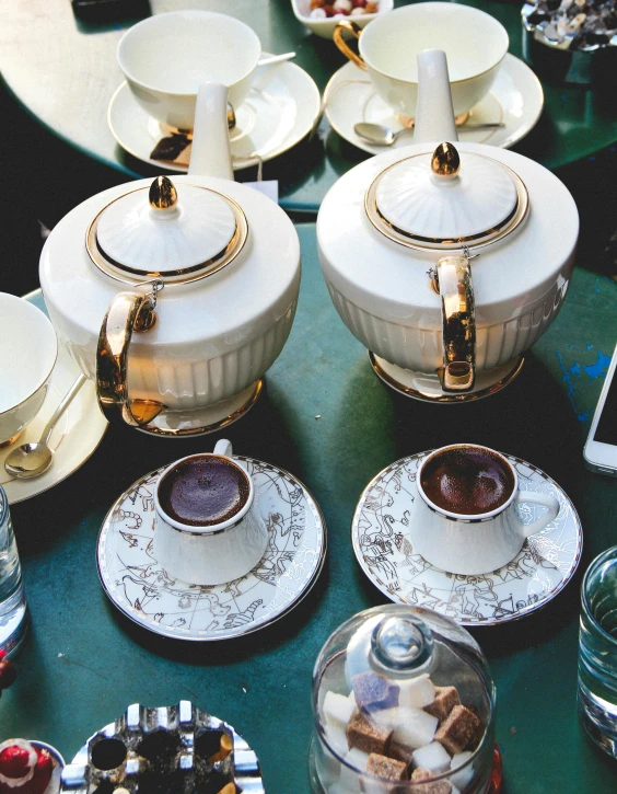 a green table topped with cups and saucers, by Lucia Peka, trending on unsplash, white and gold robes, teapots, thumbnail, brown