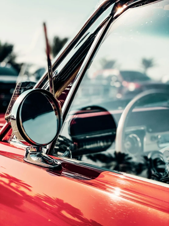 a close up of a red car in a parking lot, by Matt Cavotta, pexels contest winner, retrofuturism, lowriders, inside mirror, profile image, natural morning light