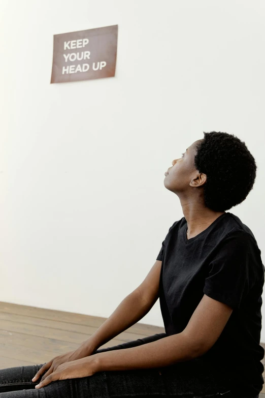 a woman sitting on the floor looking up, by Nina Hamnett, visual art, on a wooden desk, your head turns back, jemal shabazz, in the gallery