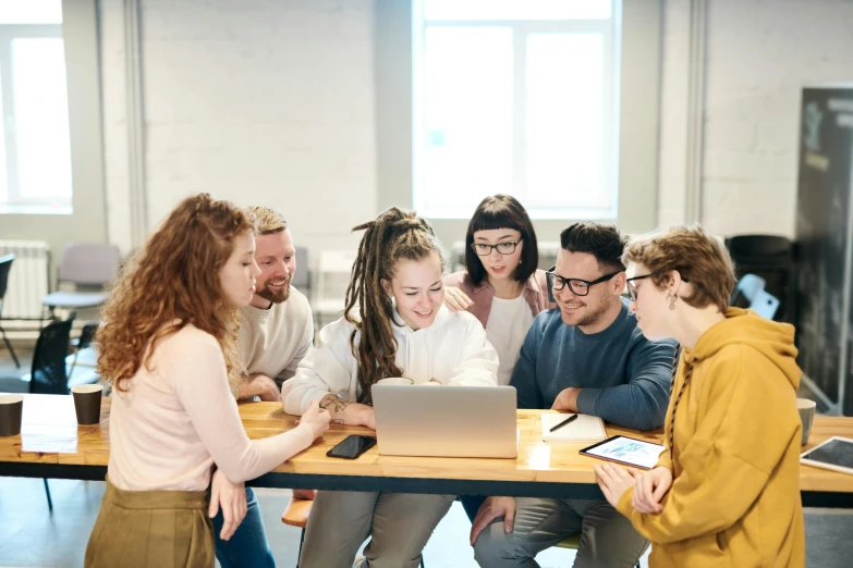 a group of people sitting around a table with a laptop, by Nicolette Macnamara, trending on pexels, school class, profile pic, hr ginger, te pae