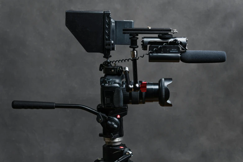 a close up of a camera on a tripod, a portrait, by Niels Lergaard, unsplash, video art, on black background, panavision psr r-200, shoulder mounted gun, product view