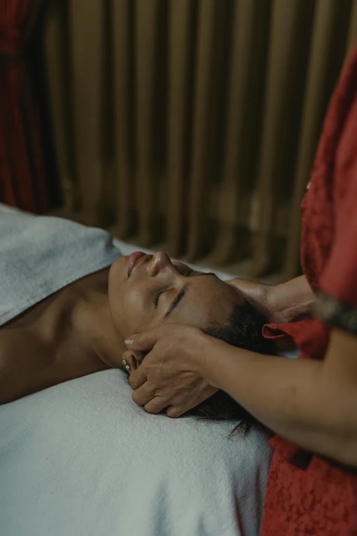 a woman getting a facial massage at a spa, trending on unsplash, renaissance, indonesia, cinematic still frame, gif, laying down