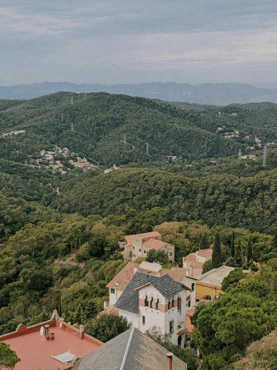 a group of buildings sitting on top of a lush green hillside, inspired by Serafino De Tivoli, pexels contest winner, les nabis, view of forest, mediterranean vista, aerial view cinestill 800t 18mm, panoramic view