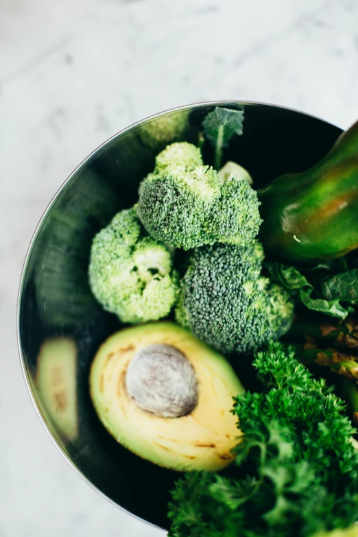 a bowl filled with broccoli and other vegetables, by Nicolette Macnamara, pexels, avocados, grey, lush greens, full product shot