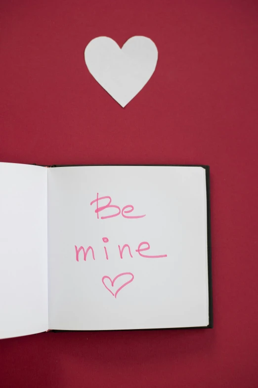 an open book with the words be mine written on it, pexels, whiteboard, deep love, thumbnail, back