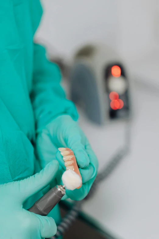 a close up of a person holding a toothbrush, surgical equipment, on a advanced lab, omniverous layered teeth, thumbnail