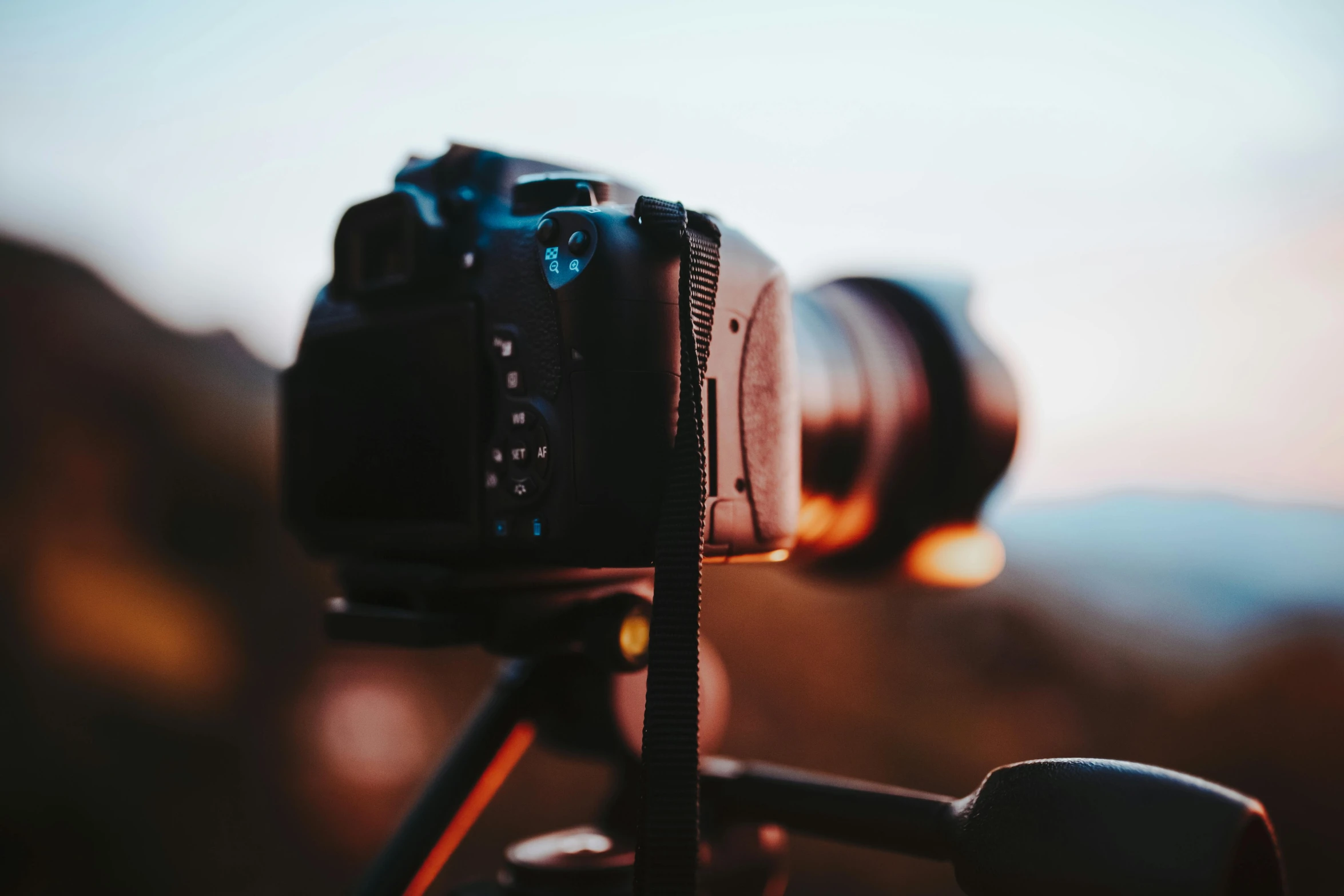 a close up of a camera on a tripod, pexels contest winner, shot at golden hour, out-of-focus background, wideangle action, video