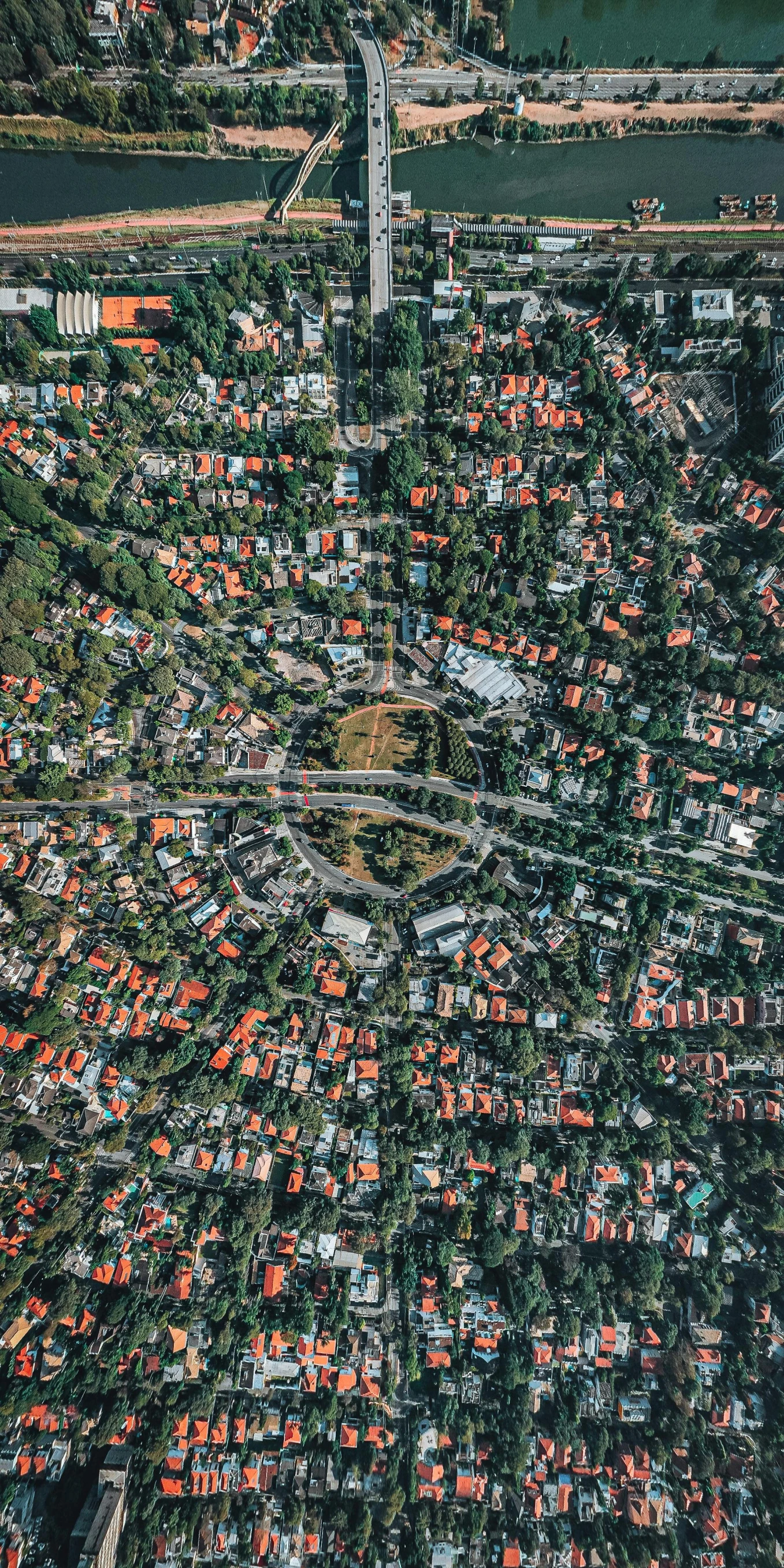 an aerial view of a city and a river, an album cover, by Adam Marczyński, pexels, houses and roads, suburban neighborhood, round-cropped, sydney