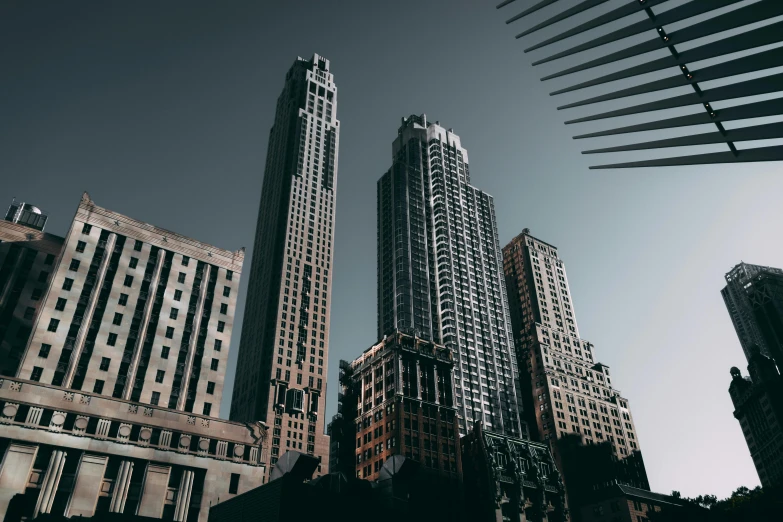 a group of tall buildings sitting next to each other, pexels contest winner, modernism, gothic building style, americana architecture, desktop wallpaper, 8k resolution”