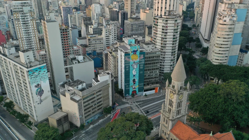 an aerial view of a city with tall buildings, by Fernando Gerassi, graffiti, freddy mamani silvestre facade, clock tower, taken in 2022, henrique alvim corrêa