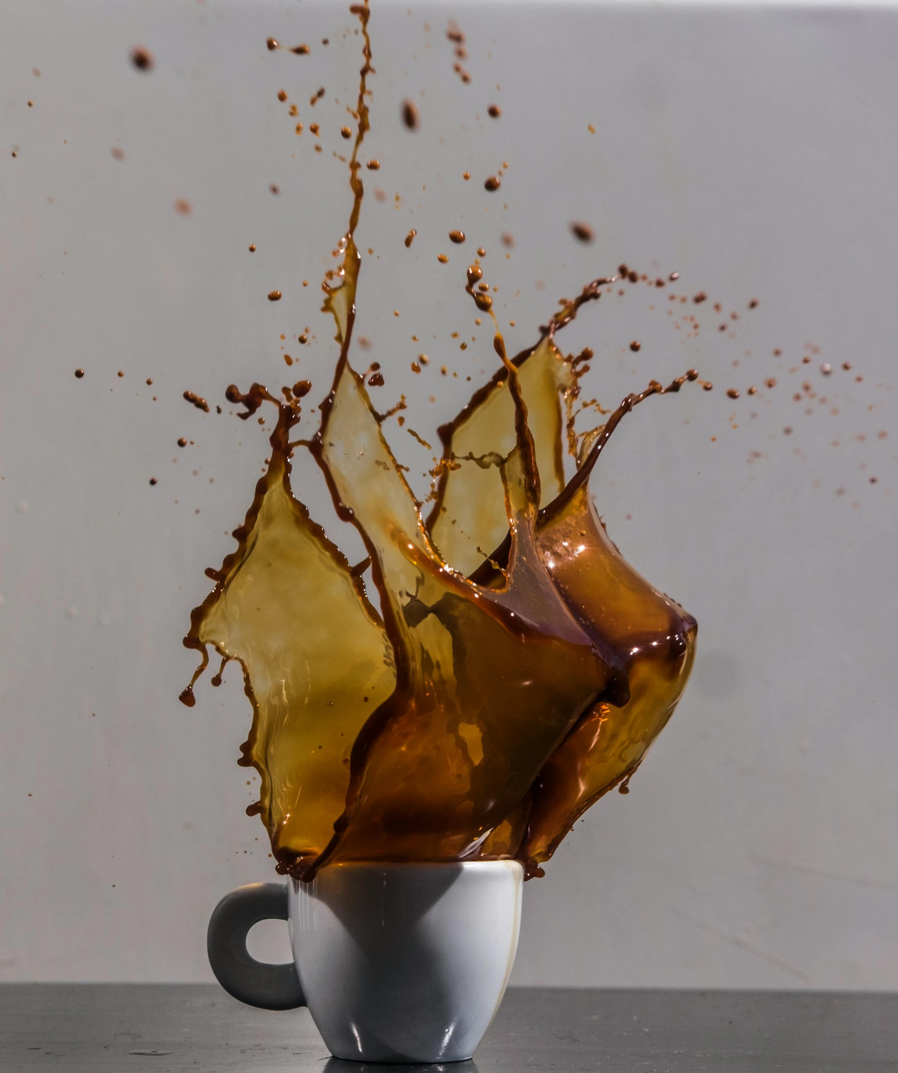 a brown liquid splashing out of a coffee cup, by Robbie Trevino, pexels, deconstructed, on display, mangled, gif