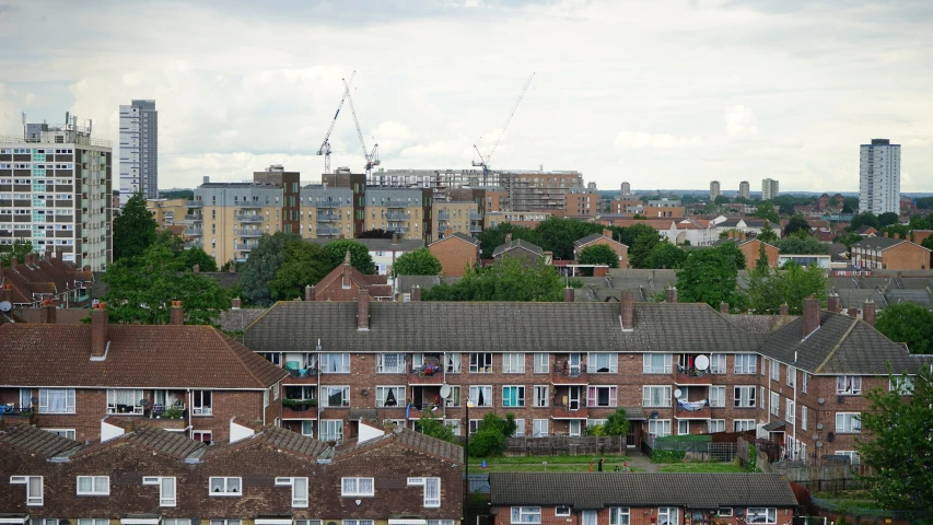 a view of a city from the top of a building, inspired by Thomas Struth, unsplash, brutalism, coventry city centre, shanty townships, low quality photo