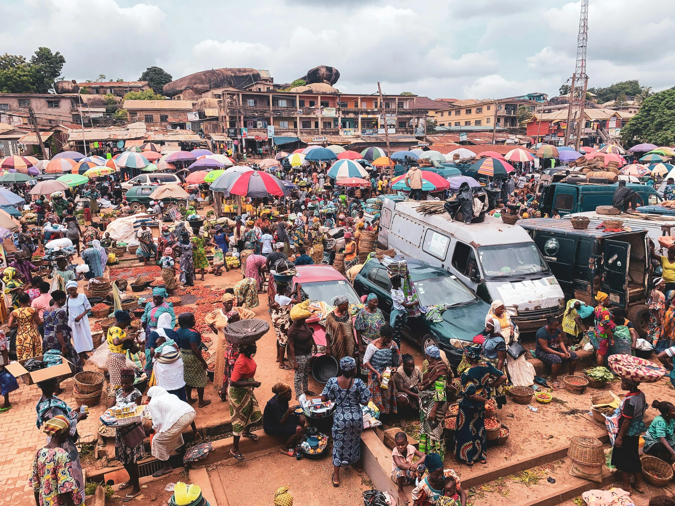 a large group of people standing around a market, by Benjamin Block, pexels contest winner, obunga, a bustling magical town, brown, godwin akpan