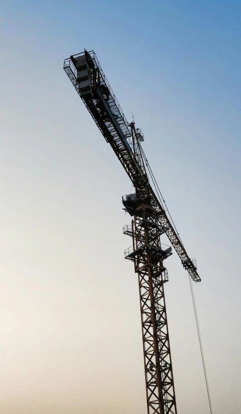 a large crane sitting on top of a body of water, a portrait, flickr, getty images, large, profile, tower