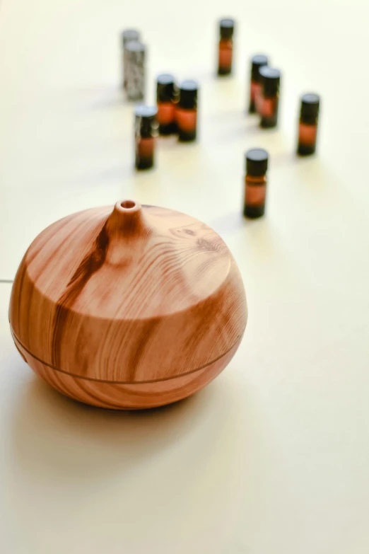 a wooden bowl sitting on top of a table, a picture, vials, misting, professional product shot, warm coloured