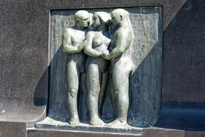 a statue of two people standing next to each other, by Ossip Zadkine, unsplash, modernism, flat shaped stone relief, helsinki, woman holding another woman, making love