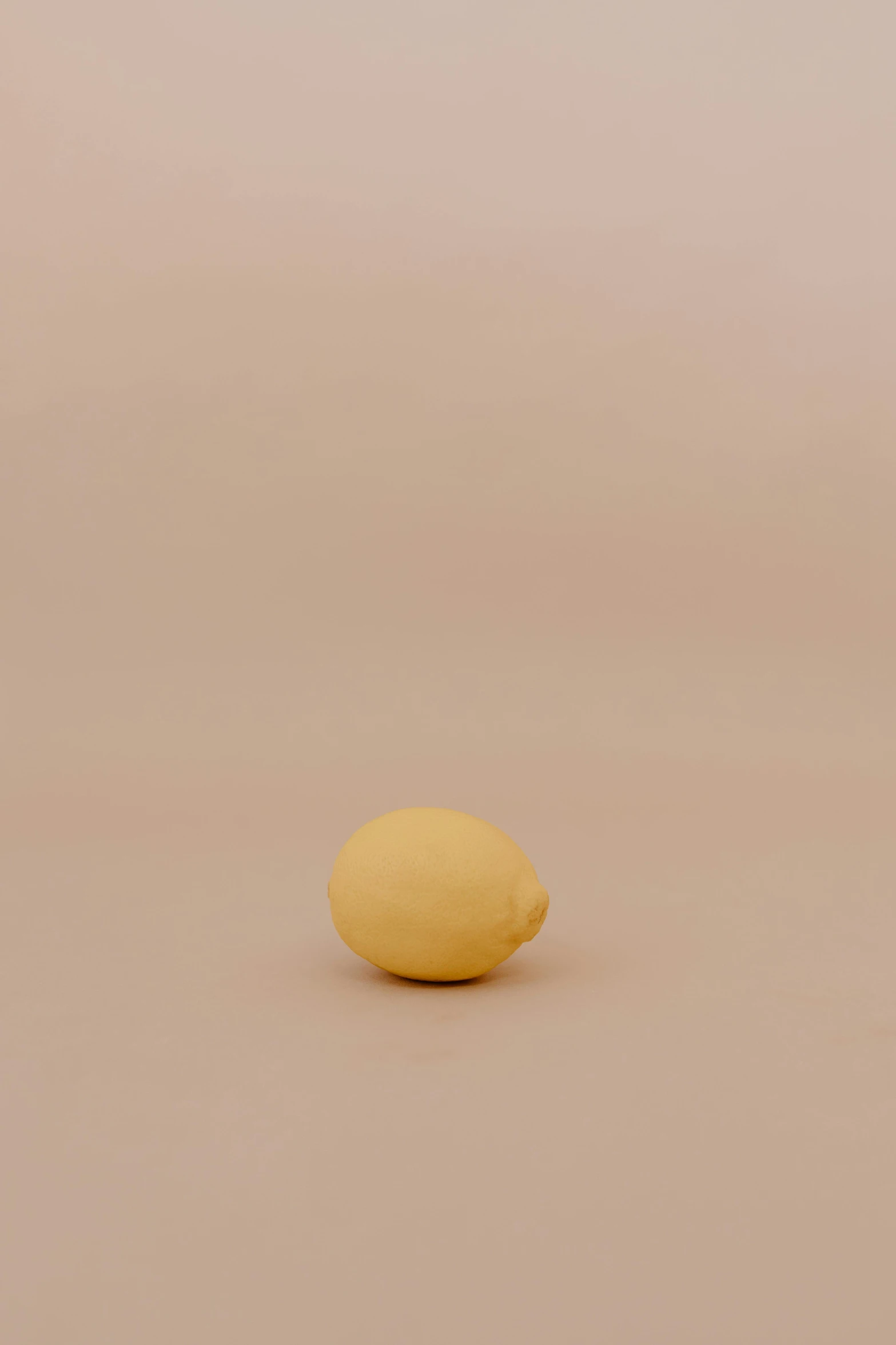 a single lemon sitting on top of a table, by Harvey Quaytman, eggshell color, miniature product photo, small, image