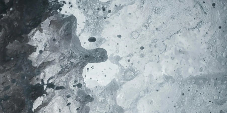 a black and white photo of a body of water, a microscopic photo, inspired by Vija Celmins, trending on unsplash, conceptual art, lightblue acrylic paintdrip tar, background image, made of liquid metal and marble, space molecules