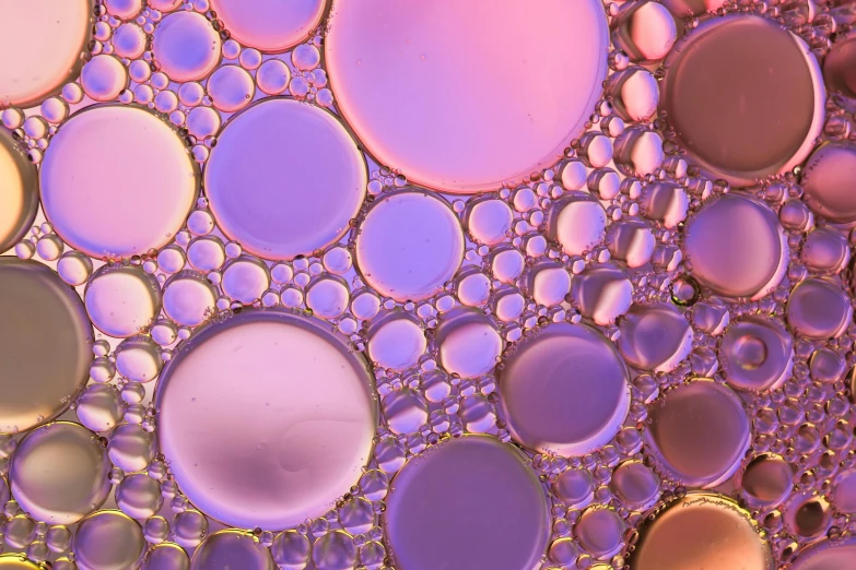 a close up of a mixture of oil and water, a microscopic photo, trending on unsplash, pointillism, pink golden hour, portholes, purple volumetric lighting, sustainable materials