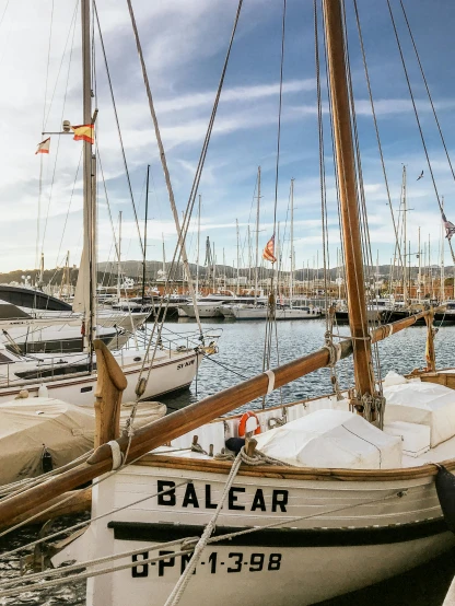 a number of boats in a body of water, by Ejnar Nielsen, pexels contest winner, saloon exterior, square, sail, low quality photo