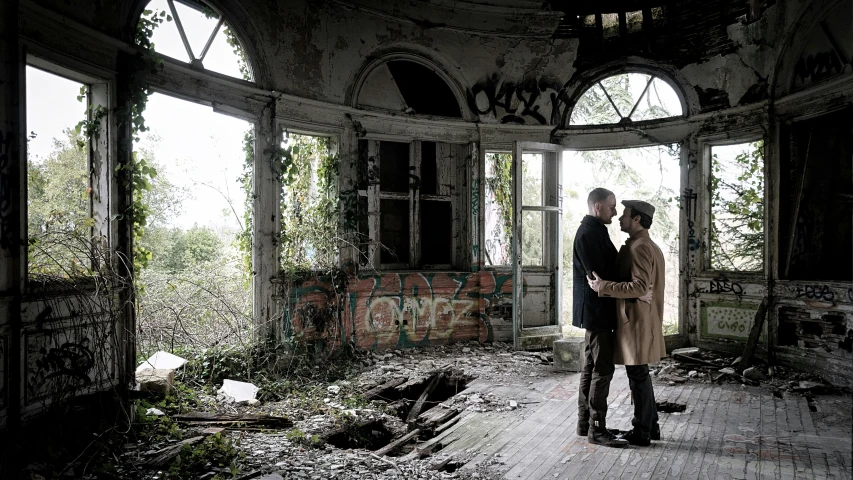 a man and a woman standing in an abandoned building, a photo, by Lucia Peka, two men hugging, inside a grand, nature taking over, lgbtq