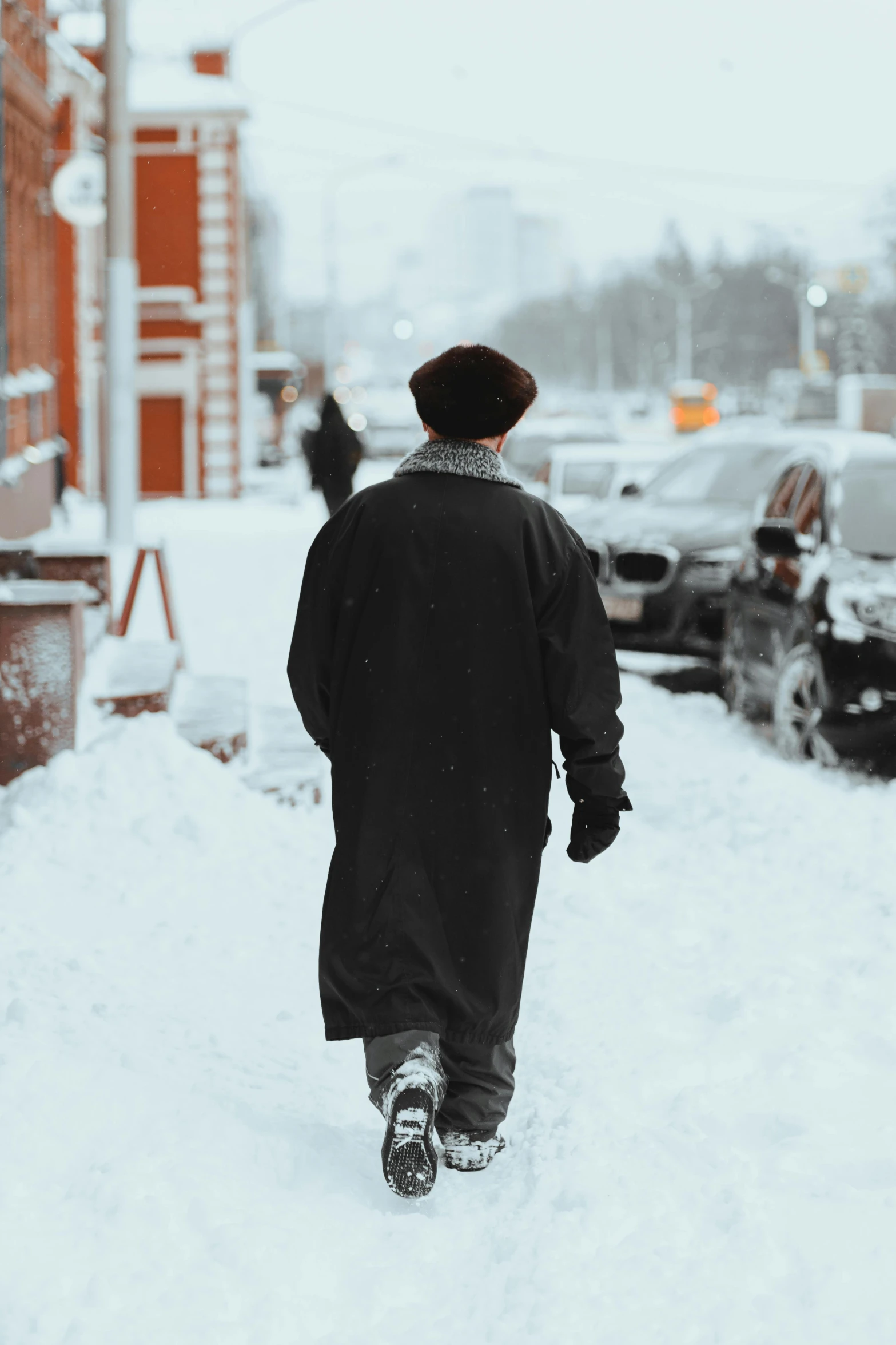 a man walking down a snow covered street, russian style, non-binary, background image, streets