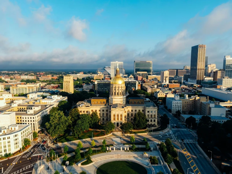 a view of a city from a bird's eye view, by Robert Lee Eskridge, unsplash contest winner, renaissance, capitol building, golden hour photograph, alabama, sunny day time