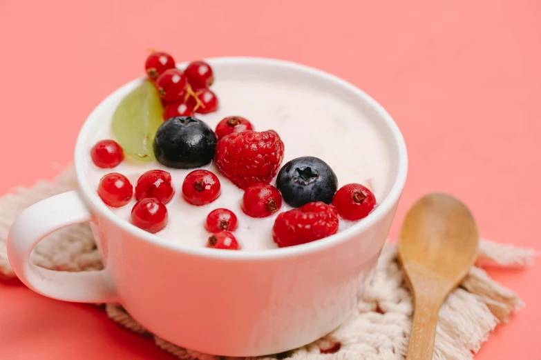 a bowl of yogurt topped with berries and raspberries, trending on pexels, red theme, avatar image, background image, soup