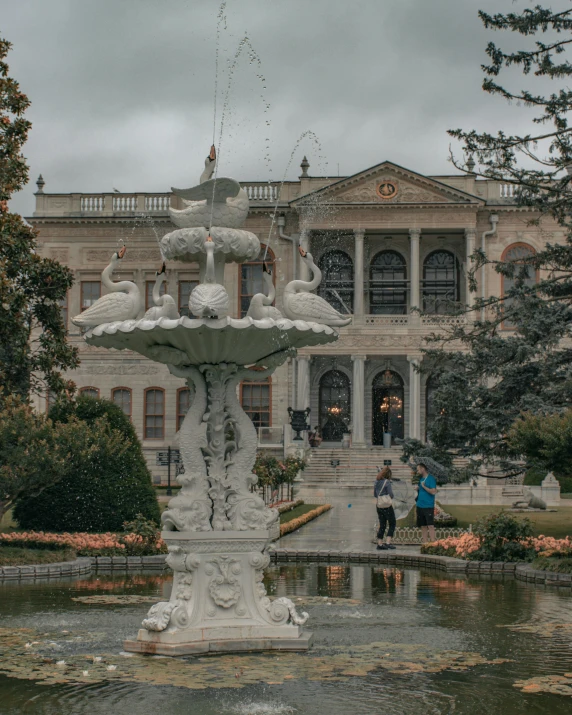 a large building with a fountain in front of it, inspired by Elsa Bleda, pexels contest winner, neoclassicism, istanbul, rose garden, low quality photo, thumbnail