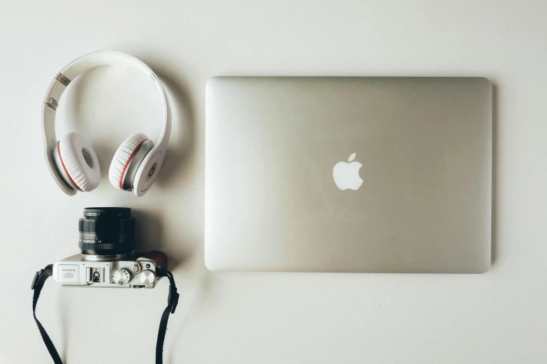 a laptop, headphones and a camera on a table, a picture, by Carey Morris, unsplash, minimalism, apple, silver accessories, white background”, grain”
