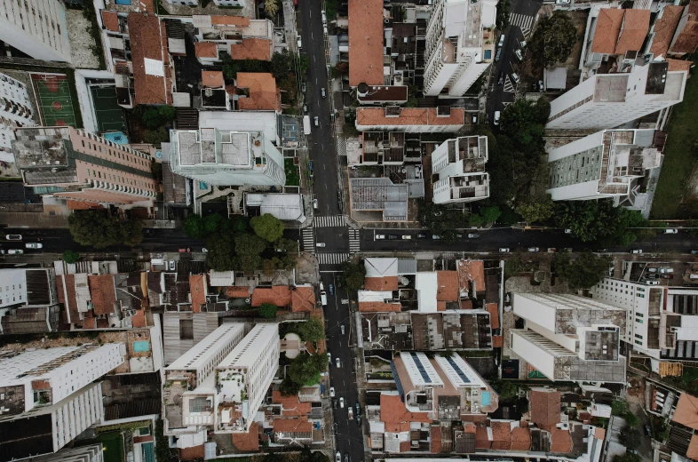 an aerial view of a city with lots of buildings, by Alejandro Obregón, pexels contest winner, hyperrealism, square, thumbnail, roofs, outdoors tropical cityscape