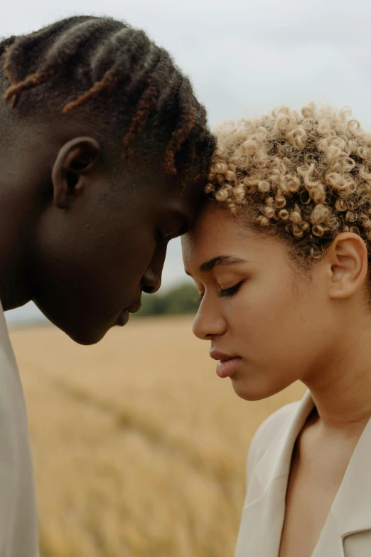 a man and woman standing next to each other in a field, trending on pexels, renaissance, short blonde afro, tenderness, black young woman, ignant