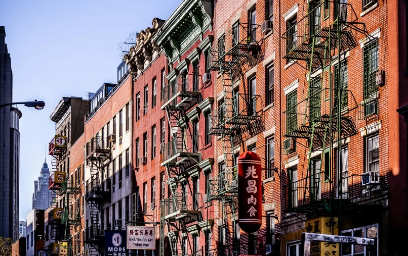 a city street filled with lots of tall buildings, a photo, fire escapes, chinese heritage, portrait image, afternoon light