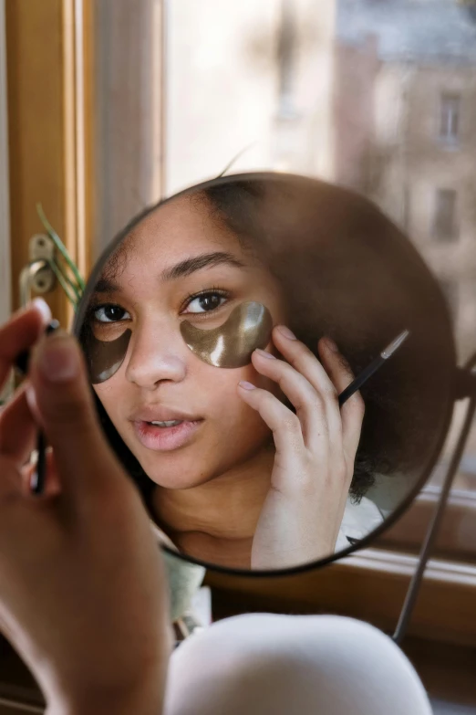 a woman taking a picture of herself in a mirror, trending on pexels, renaissance, black eye mask, mixed-race woman, essence, portrait of metallic face