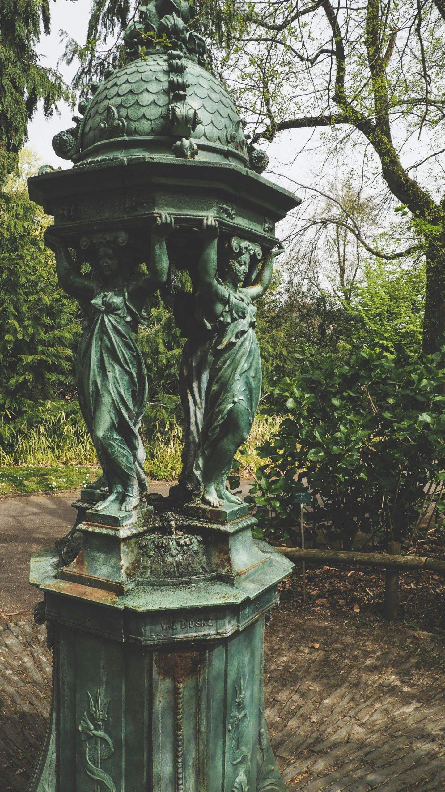 a statue sitting in the middle of a park, inspired by Jane Nasmyth, unsplash, art nouveau, overturned ornate chalice, 3 nymphs circling a fountain, copper and emerald, museum quality photo