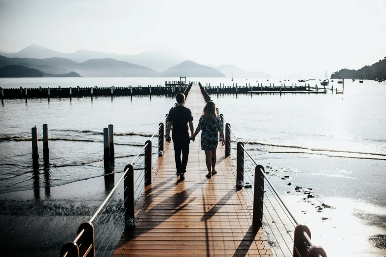 a couple of people that are walking on a dock, pexels contest winner, jordan grimmer and natasha tan, thumbnail, walkway, al fresco