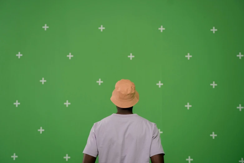 a man standing in front of a green screen, trending on pexels, visual art, bucket hat, back view. nuri iyem, wall paper, riyahd cassiem