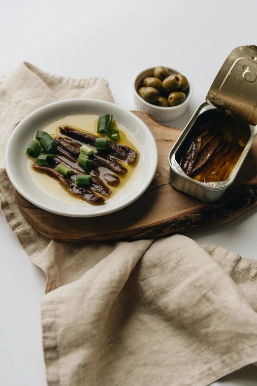 a plate of food sitting on top of a table, inspired by Ceferí Olivé, unsplash, modernism, sardine in a can, ramps, olive oil, white background and fill