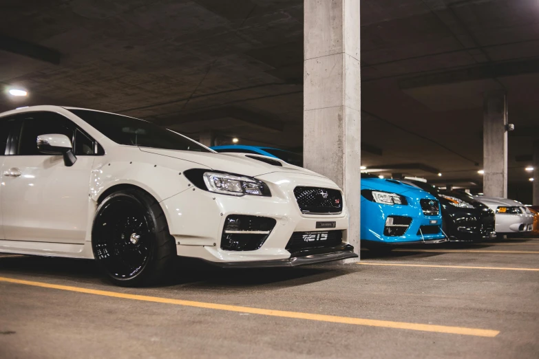 a couple of cars parked next to each other in a parking garage, inspired by An Gyeon, unsplash, subaru, avatar image, lachlan bailey, samurai vinyl wrap