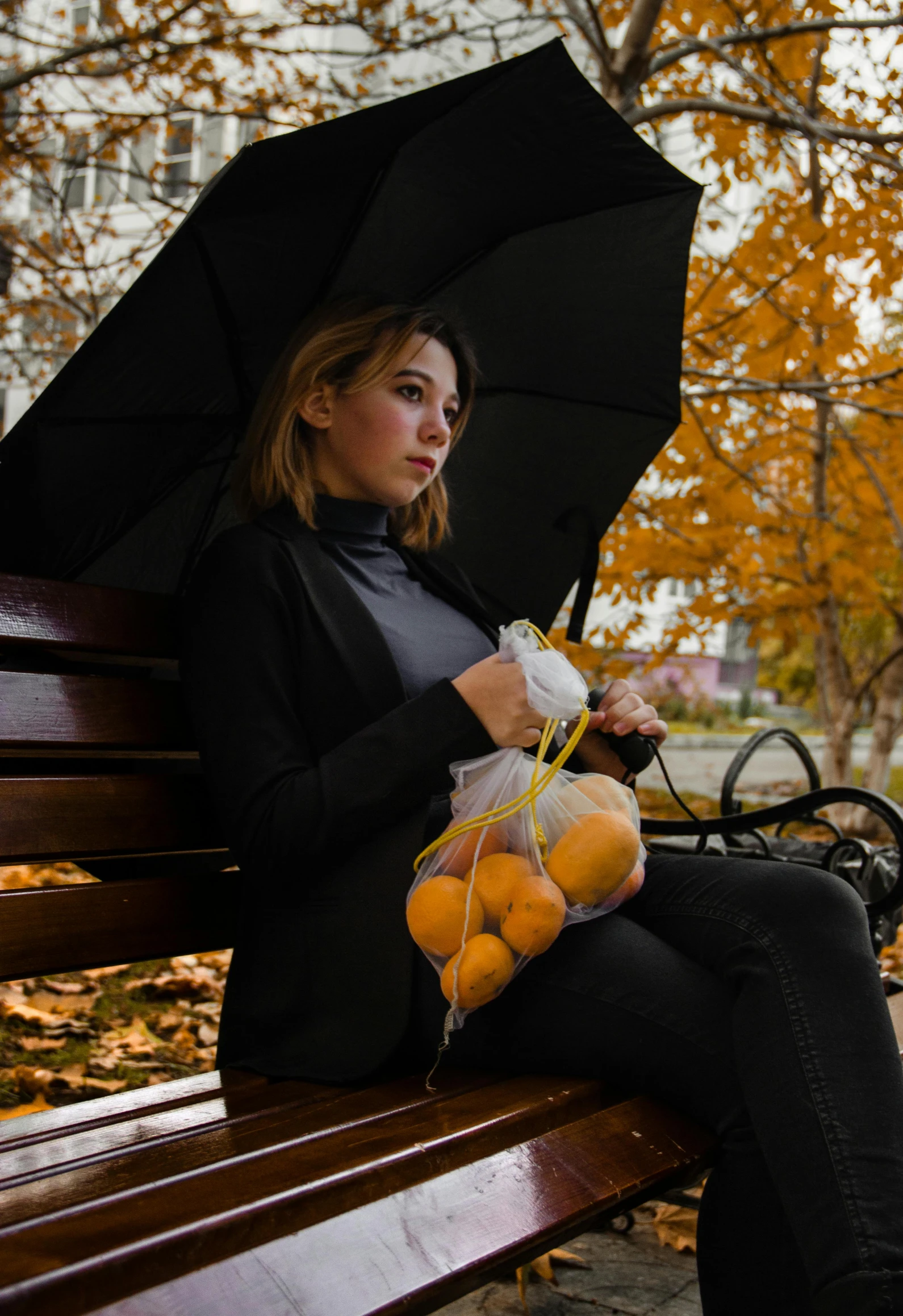 a woman sitting on a bench holding an umbrella, by Koloman Sokol, pexels contest winner, holding a tangerine, hyperrealistic fall, getting groceries, anna nikonova aka newmilky