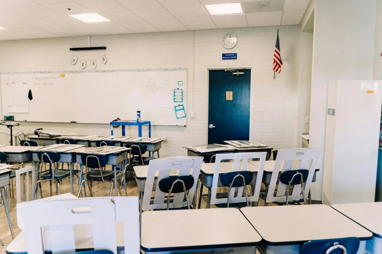 a classroom filled with lots of desks and chairs, a portrait, by Carey Morris, unsplash, fan favorite, standing in corner of room, american school, background image