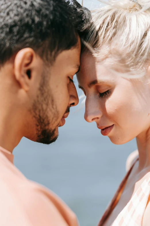 a man and a woman standing next to each other, trending on unsplash, romanticism, close up of a blonde woman, sunfaded, touching heads, tan complexion