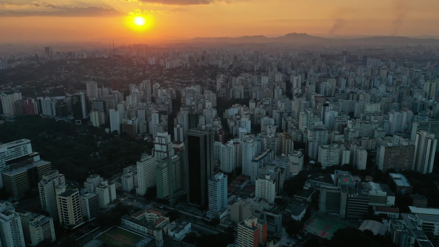 an aerial view of a city at sunset, by Fernando Gerassi, humid evening, city high-rise, lut, full frame image